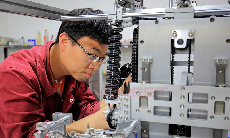 机械工程师在维护电机组装线